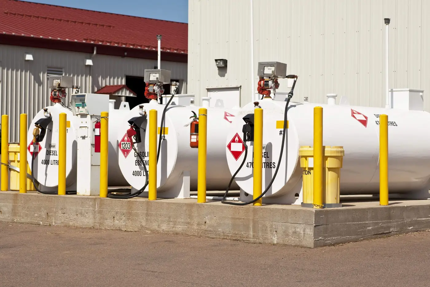 Above-ground fuel storage tanks with bollards at a commercial site