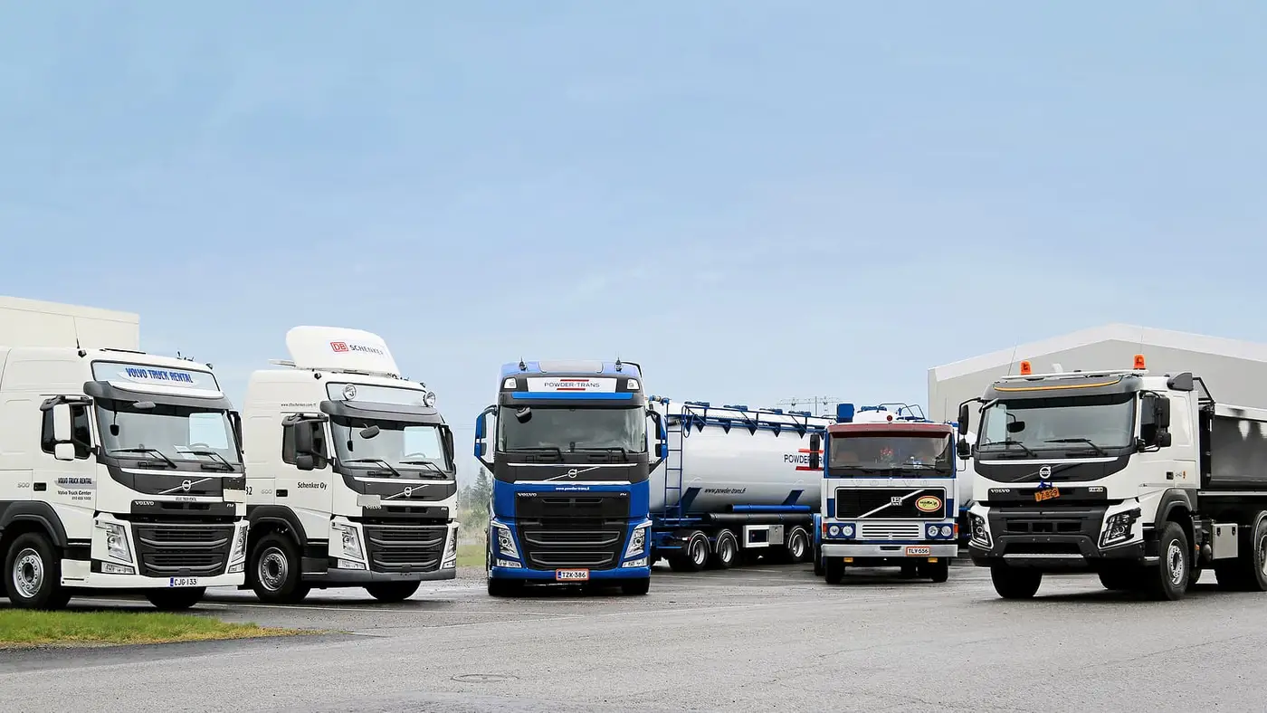 Row of semi trucks at a trucking company yard