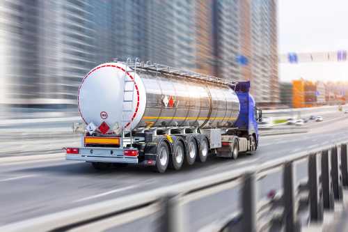 Stainless fuel tanker truck on the highway making a commercial fuel delivery