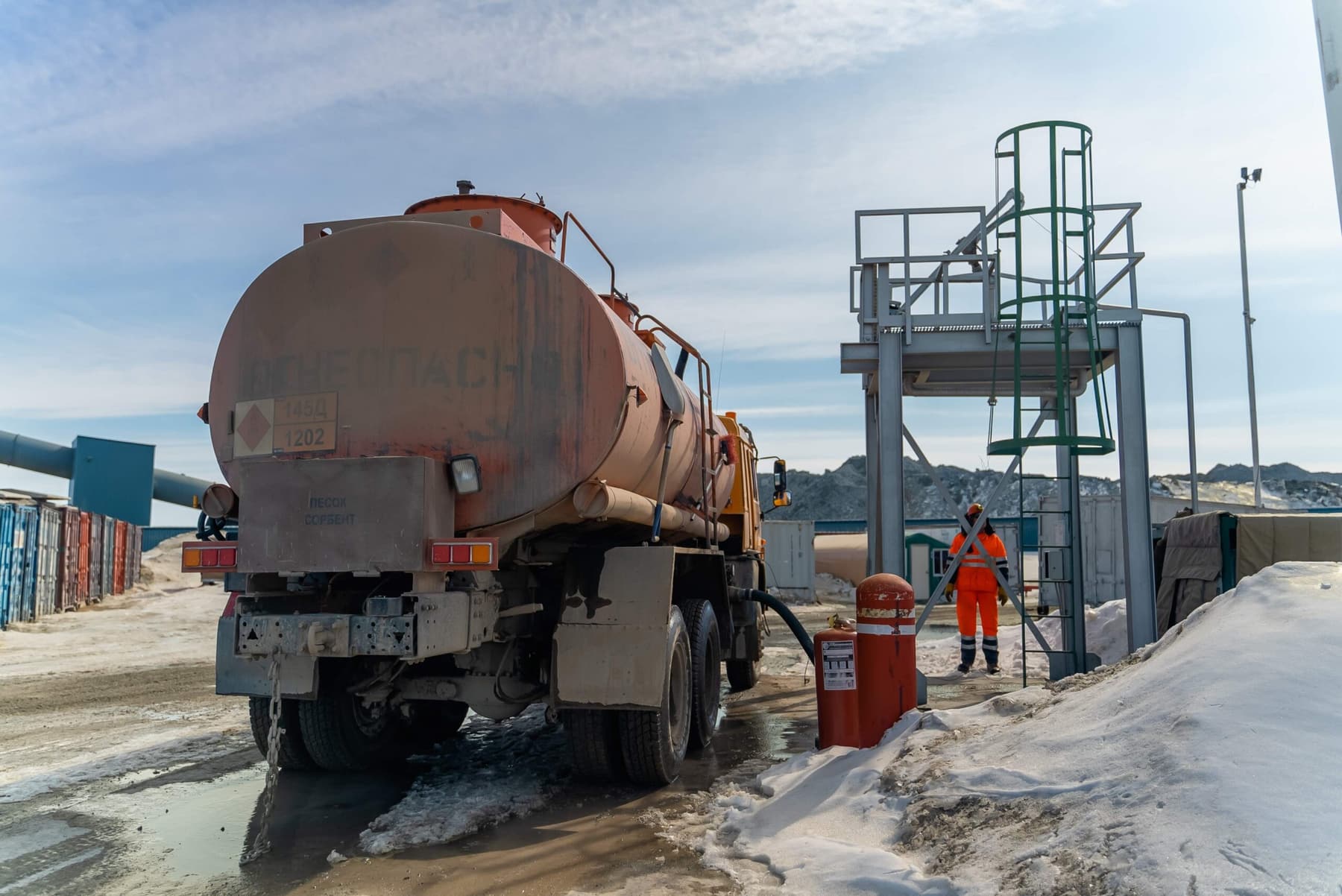 Fuel truck making an emergency delivery at an industrial site in winter