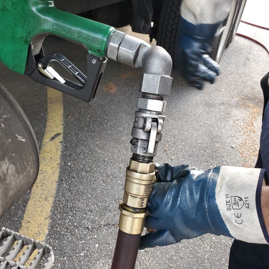 Fuel nozzle and delivery hose during on-site fuel delivery to a vehicle