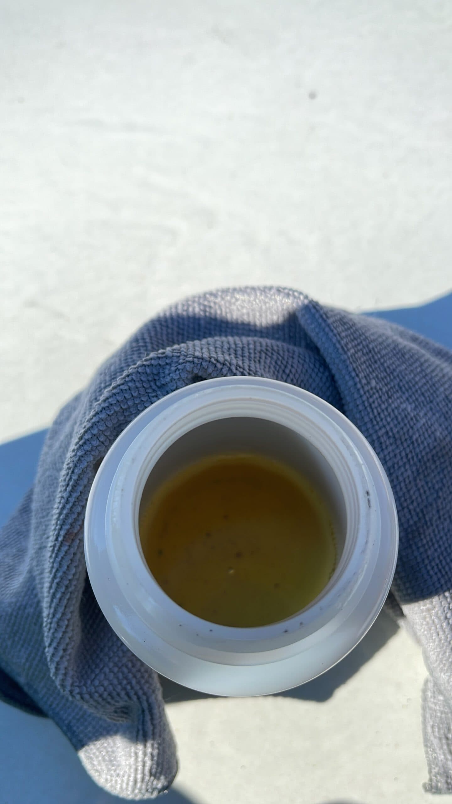 Close-up of dark amber diesel fuel with visible dark particulate debris